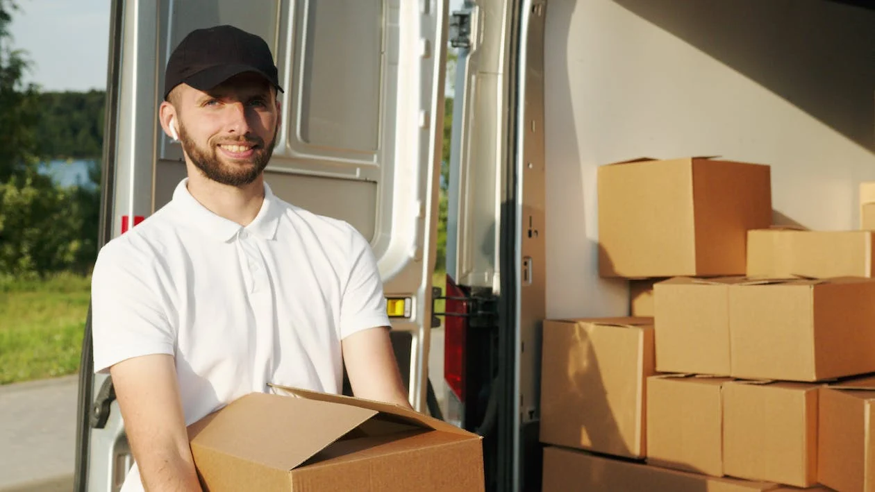 fully loaded van with worker outside holding a box 2